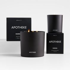 three black candles sitting next to each other on top of a white surface with the words apothheke printed on them