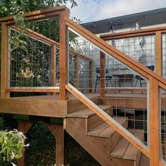 a wooden deck with metal railing and stairs