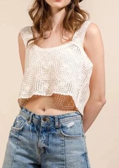 a young woman wearing jeans and a white crop top