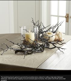 a table with candles and branches on it