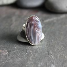 This ring has a huge oval brown Botswana agate set in a fine and sterling silver bezel setting on a sturdy silver band.  Size 9 1/4 Plain Silver Rings, Sea Glass Ring, Botswana Agate, Silver Gemstone Jewelry, Difficult Times, Wide Band Rings, Agate Ring, Unique Gifts For Her, Ring Unique