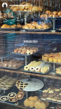 a display case filled with lots of different types of doughnuts and pastries