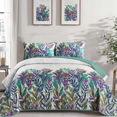 a bed with green and purple leaves on it