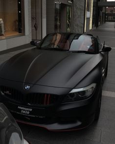 a black bmw z4 convertible parked on the street