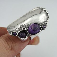 New Handmade Sterling Silver Amethyst Ring from my collection. The ring is made of 925 sterling silver with five natural genuine natural Amethyst (oval 12mmX8mm and four round 6mm, 4mm, 3mm, 2mm). Must see! Unique handcrafted Silver Ring. Statement ring, fits any occasion. Can be worn alone or next to other rings, at both way it will show your unique fashion style. Perfect Gift for you and your loved one. Dimensions: Front Width: 39mm / 1.535 in., Back width: 8mm / 0.314 in. Material: Sterling S Purple Stone Rings, Antique Engagement Ring, Purple Amethyst Ring, Purple Rings, Bold Rings, Big Rings, Unisex Ring, Purple Stones, Silver Rings Handmade