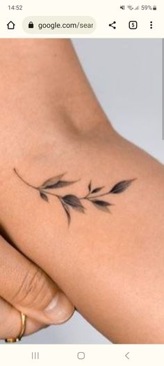 a woman's arm with a small tattoo on it