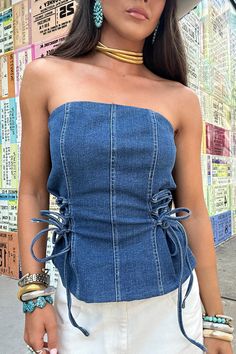 Elevate your style with our Denim Bustier Top - the ultimate addition to any wardrobe. Made of high-quality medium wash denim, this top boasts a strapless design and adjustable tie details on the sides for a personalized fit. Perfect for any occasion, whether you're having a night out, attending a country concert, or simply running errands. This versatile top is the perfect transition piece for all seasons. 70% Cotton, 28% Polyester, 2% Spandex denim strapless corset top adjustable tie side deta Denim Bustier Top, Strapless Corset Top, Denim Bustier, Denim Corset Top, Denim Corset, Jean Crafts, Strapless Corset, Fall Transition, Country Concert