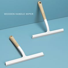 two wooden handle wipers on a blue surface