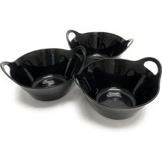 three black dishes are sitting on a white surface