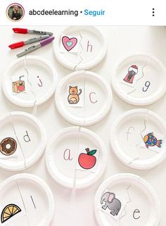 paper plates with different types of letters and numbers are arranged in the shape of an apple