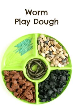 a green plate filled with different types of food and the words worm play dough on it