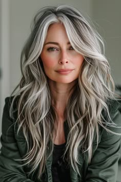 Combine long layers with balayage for a dynamic and stylish look. These hair styles for women over 50 offer versatility and an elegant flair that complements your natural beauty. Gray To Blonde Hair Balayage, White Hair With Dark Highlights, Balayage Hair For Greying Hair, Grey Hair Blending Blonde, Women With Long Grey Hair, Long Hair Grey Highlights, Grey Colored Hair For Women, Highlights With Gray Hair Natural, Light Brown And Silver Hair