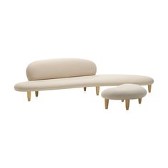 an upholstered couch and footstool with two stools in front of it