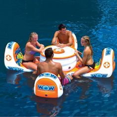 three people are sitting on an inflatable boat