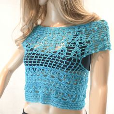 a mannequin wearing a blue crochet top