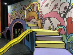 an indoor play area with painted walls and stairs