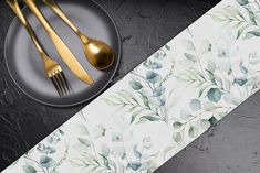 a plate with two forks and spoons on it next to a wallpaper design