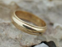 Here is a timeless and classic 14 k wedding band. The band measures approx. 6mm in thickness. The ring has personal engraving inside that is hard to read, but looks like '' Wed-Love M. I. Lovin You S.S.'' There is a beauty in the simplicity of this design. The size is 9 1/4-9.5. The inside of the ring is stamped 14k. The weight is 6 g. This item is pre-owned vintage and may show some wear commensurate with its age. We will point out any flaws, post pictures, and describe to the best of our abili Classic 14k Stamped Bands, 14k Stamped Round Band Engraved Ring For Marriage, 14k Stamped Engraved Ring For Marriage, Stamped 14k Round Band Engraved Ring For Marriage, Classic 14k Stamped Rings For Marriage, Classic Engraved Ring With Thick Band For Anniversary, Classic Round Bands Stamped 14k, Classic Round Band Jewelry For Marriage, Classic 14k Gold Marriage Rings