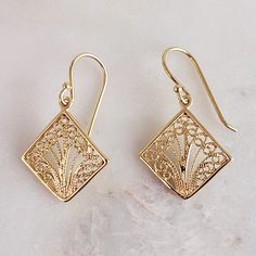 Elevate your style with our Aesthetic Filigree Square Dangle Earrings, a blend of bohemian charm and timeless elegance. These unique earrings feature intricate filigree work in a square dangle design, crafted in gold-plated metal. Measuring approximately 18mm in width (about 3/4 inch) and 30mm in length (about 1 3/16 inches), they offer a striking look that's perfect as a unique gift or for adding a minimalist touch to any outfit." ✓ Bohemian Charm: Intricate filigree square dangle design. ✓ Gol Elegant Rectangular Jewelry With Intricate Design, Elegant Hypoallergenic Rectangular Jewelry, Elegant Rectangular Hypoallergenic Jewelry, Elegant Square Pendant Earrings As Gift, Elegant Nickel Free Square Pendant Earrings, Gift Earrings With Square Pendant For Pierced Ears, Gift Square Pendant Earrings For Pierced Ears, Square Pendant Earrings For Gift, Elegant Rectangular Filigree Jewelry