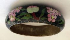 "This is a beautiful early Chinese export very wide cloisonne enamel bangle bracelet. handpainted Cobalt black Peonies and peach. hollow with a brass interior. black background with multi colored flowers. Brass. Art Deco Jewelry c1900 6/8\" Wide x 2 5/8 \" Internal Circumference. Weight 1.97 oz. Please examine the photos carefully, I take great effort to take quality photos of all angles and a picture is worth a thousand words. I guarantee the item to be as described. If you have any questions f Black Peonies, Black Peony, Brass Interior, Multi Colored Flowers, Brass Art, Enamel Bangle, Colored Flowers, Chinese Export, Cloisonne Enamel