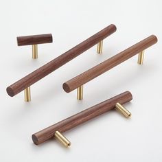 four brass and wood handles on white background