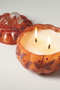 two candles sitting next to each other on a table