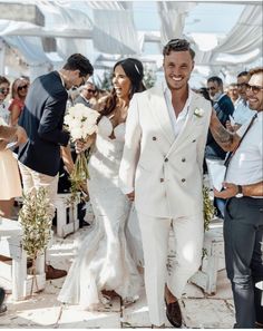 the newly married couple are walking down the aisle