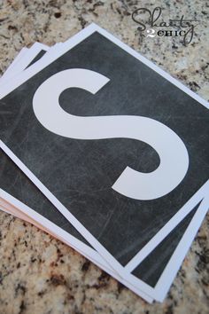 three black and white stickers with the letter s on them sitting on a counter