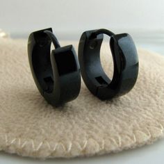 A pair of stainless steel medium hoop earrings for men.  These black steel hoops are durable and simple to wear.  These men's hoop earrings require very little maintenance.  We sell this style as a pair or a single earring. Please select from the drop down menu during checkout.This 13mm is considered a 'medium' size which leaves a small, yet comfortable gap between hoop and ear. The 4mm thickness is a standard thickness that won't go wrong. A must-have men's accessories.  We offer premium earrin Modern Black Hypoallergenic Hoop Earrings, Black Stainless Steel Hoop Earrings, Modern Black Stainless Steel Hoop Earrings, Black Hypoallergenic Hoop Earrings In Stainless Steel, Minimalist Black Stainless Steel Hoop Earrings, Minimalist Black Small Hoop Huggie Earrings, Small Black Hypoallergenic Hoop Earrings, Black Hypoallergenic Hoop Earrings For Everyday, Black Hypoallergenic Huggie Earrings