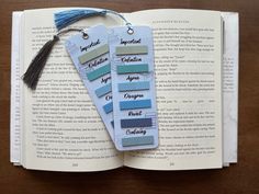 two bookmarks with different shades of blue and grey on top of an open book