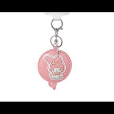 a pink keychain with an animal on it's front and back side