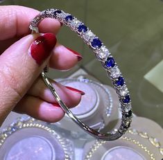 What's better than a white gold bangle? Diamond & Sapphire gold bangle of course! You'll adore the sparkling diamond stones that enrich this bangle with brilliance. You can wear this fabulous bangle with absolutely anything.Metal: 18K White GoldDiamond Weight: 11 Round Brilliant cuts 1.66ct t.w.Sapphire Weight: 10 Round cuts 1.77ct twSetting: ProngBangle Width: 57mm X 49mm Estimated production time is 4 - 5 weeks. Bangle Diamond, White Gold Bangle, Sparkling Diamond, Gold Bangle, Sparkle Diamonds, Round Brilliant Cut Diamond, Diamond Stone, Gold Bangles, Brilliant Cut Diamond