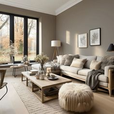 a living room filled with furniture and large windows