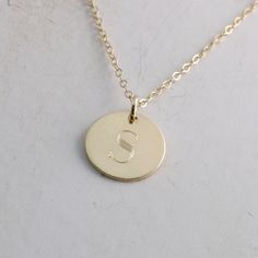 "Solid gold engraved initial necklace is a family heirloom that will be cherished and treasured for many years... it is the PERFECT gift! PICTURE IS ENLARGED TO SHOW DETAIL! SEE SECOND PICTURE FOR SIZE COMPARISON. PLEASE READ BELOW FOR ACTUAL MEASUREMENTS!! Your choice of one, two, or three solid gold 1/2\" (13mm) discs have been personalized just for you with a classy block font in a large 7mm size and it is GORGEOUS! (Font is shown in picture #6 above) The pendants hang from a solid 14k gold 1 Personalized Yellow Gold Necklaces For Anniversary, Personalized Yellow Gold Necklace For Anniversary, Formal Initials Nameplate Necklace, Formal Nameplate Initials Necklace, Personalized Heirloom Silver Necklace, Heirloom Personalized Silver Necklace, Heirloom Silver Personalized Necklace, Heirloom Style Personalized Necklace For Anniversary, Silver Nameplate Necklace Stamped 14k