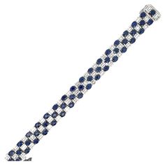 Fifty oval cut blue Sapphires weighing 24.02 Carats with alternating illusion style diamonds containing 234 round brilliants 1.49 carats and 250 baguettes weighing 6.16 carats, 18 Karat White Gold. Modern Bracelets, Sapphire Diamond, Oval Cut, Round Brilliant, Blue Sapphire, Jewelry Bracelets, Sapphire, White Gold, Bracelet