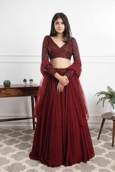 A lehenga is a traditional dress for women. It is worn on special occasions such as weddings, festivals and parties or any formal event. It can also be worn at casual events as per the occasion. The versatility of this outfit makes it easy to style and wear just about anywhere you want to go! The Lehenga comes in various styles but most of them come with an embroidered top and a draped bottom (long skirt). The embroidery can be done in different ways depending on your personal preference: there Maroon Net Lehenga, Maroon Skirt And Top, Indian Party Wear Lehenga, Simple Lahanga Design, Women Lehenga Designs, Lehenga With Dupatta Style, Skirt And Top For Party, Maroon Lehenga Simple, Burgundy Lengha