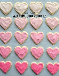 valentine's day cookies with pink and white frosting in the shape of hearts