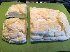 four pieces of bread sitting on top of a green cutting board