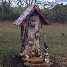 a tree stump house with gnomes on it