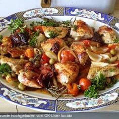 a white plate topped with meat and veggies on top of a wooden table