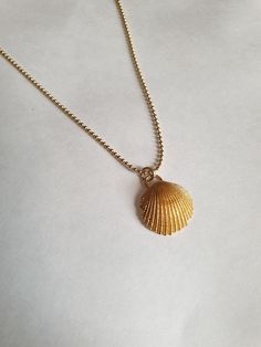 A sea shell necklace made of natural shells casted in brass and plated with quality, nickel free 14k gold plating. The necklace is made of 14k gold filled. Delicate Gold Necklace For Beach, Ocean-inspired Gold Shell Charm Necklaces, Gold Shell Necklace With Ocean-inspired Style, Gold Shell Necklace Ocean-inspired, Gold Shell Necklace With Clavicle Chain, Gold Shell-shaped Necklace With Clavicle Chain, Gold Shell Ocean-inspired Necklace, Dainty Gold Shell Charm Necklace, Gold Ocean-inspired Shell Necklace