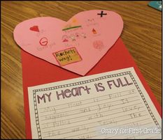 a paper heart with writing on it next to a piece of paper that says my heart is full