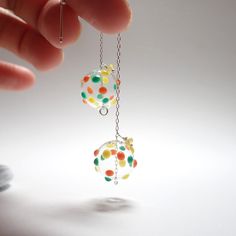 Bubbles earrings effortlessly capture both shadow and light, creating a mesmerizing play of colours under the sunlight. Handcrafted with care, each pair is a unique expression of artisan craftsmanship Materials: * Hand blown glass * Sterling Silver Size: * Glass diameter 1.5 cm  * Drop length 8 cm Glass art in the below link: https://www.etsy.com/ca/shop/NaheyiyiStone?ref=seller-platform-mcnav&search_query=glass+earrings Please Note： Glass is fragile. Please do not wear it when engaged in danger Blown Glass Jewelry, Stained Glass Earrings, Bubble Earrings, Glass Beads Jewelry, Green Dot, Handmade Glass Beads, Glass Earrings, Glass Jewelry, Hand Blown Glass