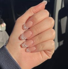 a woman's hand with french manies and some glitters on her nails