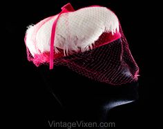 "This dome-shaped 1960s spring hat is a soft layer of thick white feathers over a base of vivid pink velvet, so charming and coy with a \"cage\" of veiling. Measurements 20 3/8 Inches Circumference at inside base of crown, approx Height 3 Inches Era 1960s Label Union label to inside back Materials White feathers, shocking pink synthetic velvet and matching diamond pattern net, matching pink stiff buckram frame Closure None needed Condition Good Condition Detail Barely worn, the netting has 6-8 s Retro Pink Brimmed Hat, Vintage Pink Fitted Fascinator, Vintage Pink Adjustable Mini Hats, Vintage Pink Mini Hat With Curved Brim, Vintage Pink Costume Hats And Headpieces For Party, Vintage Pink Mini Hat With Short Brim, Vintage Pink Party Hat And Headpiece, Vintage Pink Mini Hat For Party, Pink Vintage Costume Hat For Parties