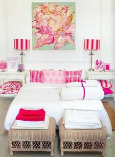 a bedroom with pink and white decor on the walls