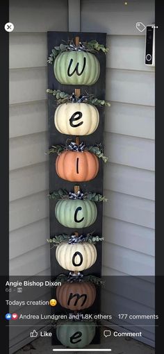 pumpkins are arranged in the shape of numbers on a wall hanging from a door