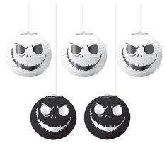 halloween decorations hanging from strings with faces on them