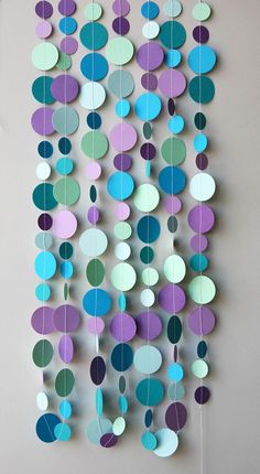 paper circles hanging from the side of a wall