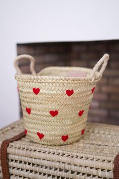 a woven basket with red hearts on it